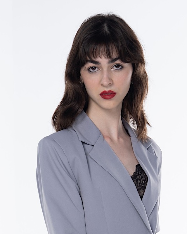 Red lip with smudged liner, editorial styling